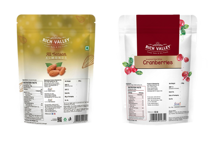 Two Rich Valley packages of almonds and cranberries on white background
