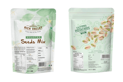 Two packages of Rich Valley roasted seeds mix and California pistachios on a white background